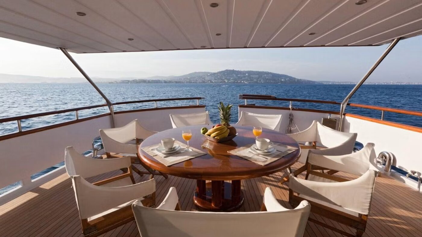 Aft deck dining table overlooking the coast